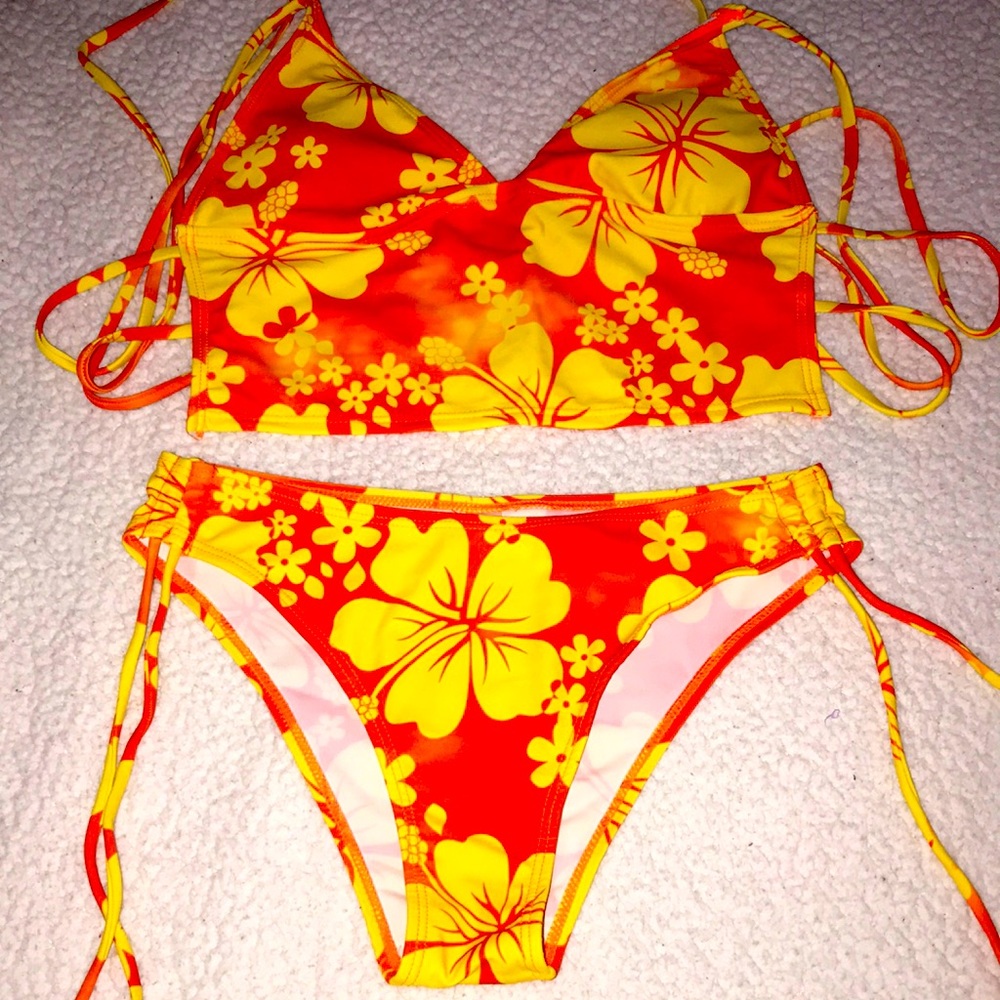 A orange and yellow floral two piece bathing suit